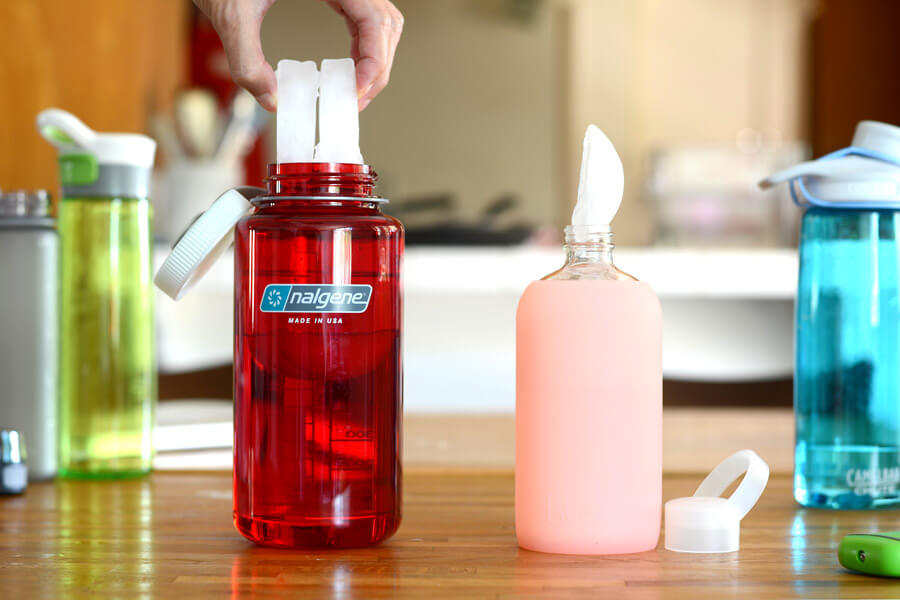 adding ice to water bottles