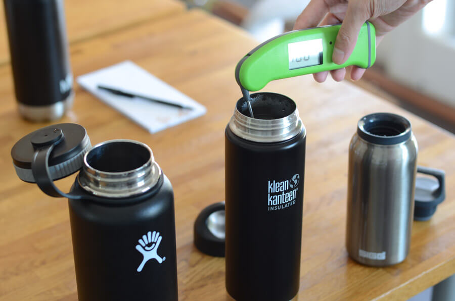 testing water bottle temperatures with thermometer