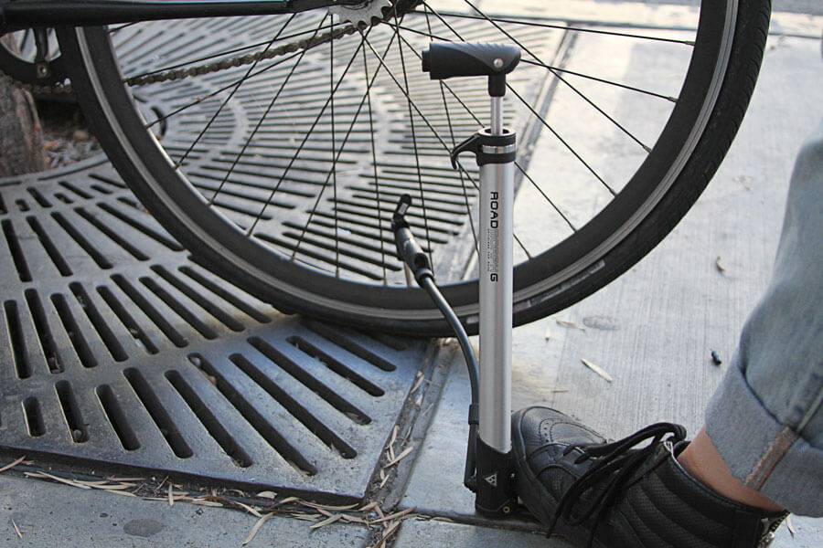 the Road Morph pump standing vertically to pump a tire