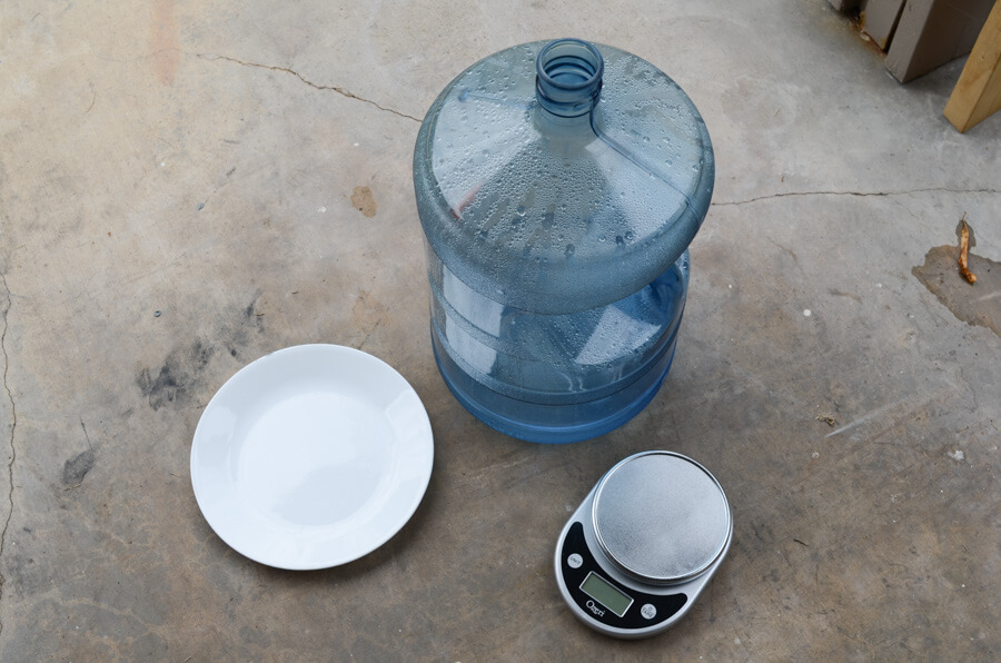 A scale, plate, and water jug for PSI and GPM testing