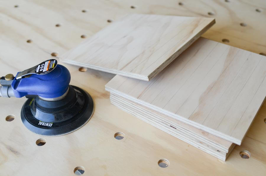 sander and plywood sheets in a sanding test