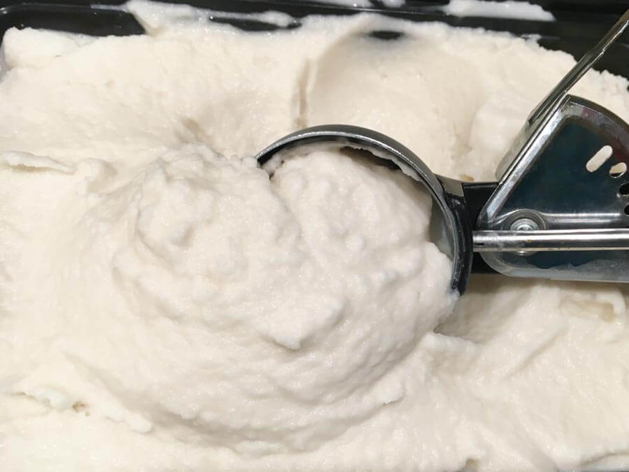 scooping white coconut ice cream