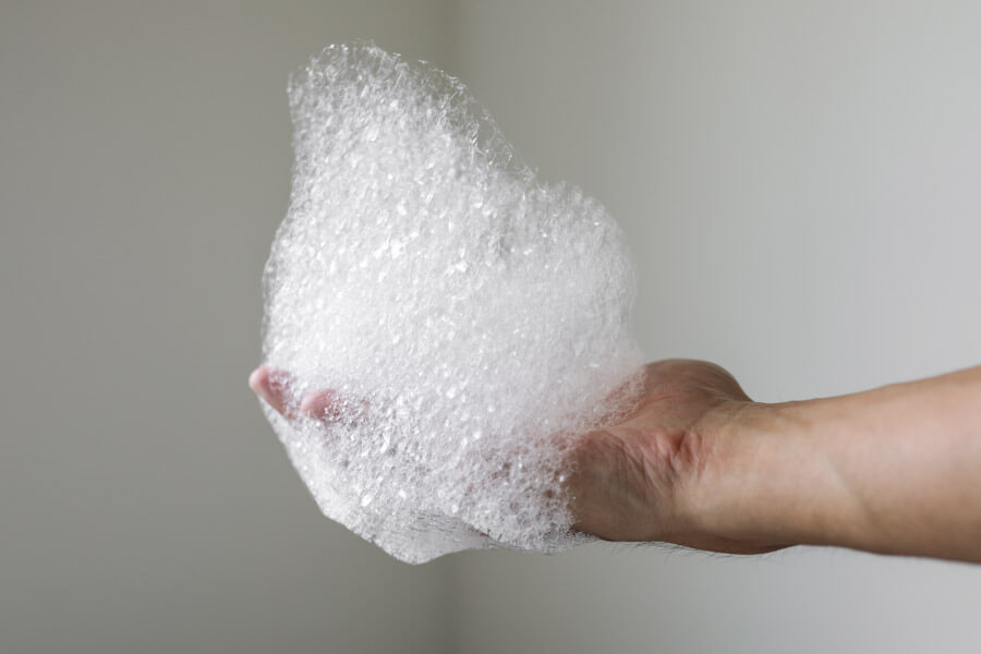 hand holding soap bubbles for suds test