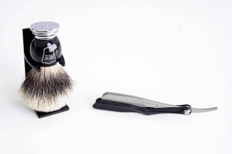 a straight razor and a brush