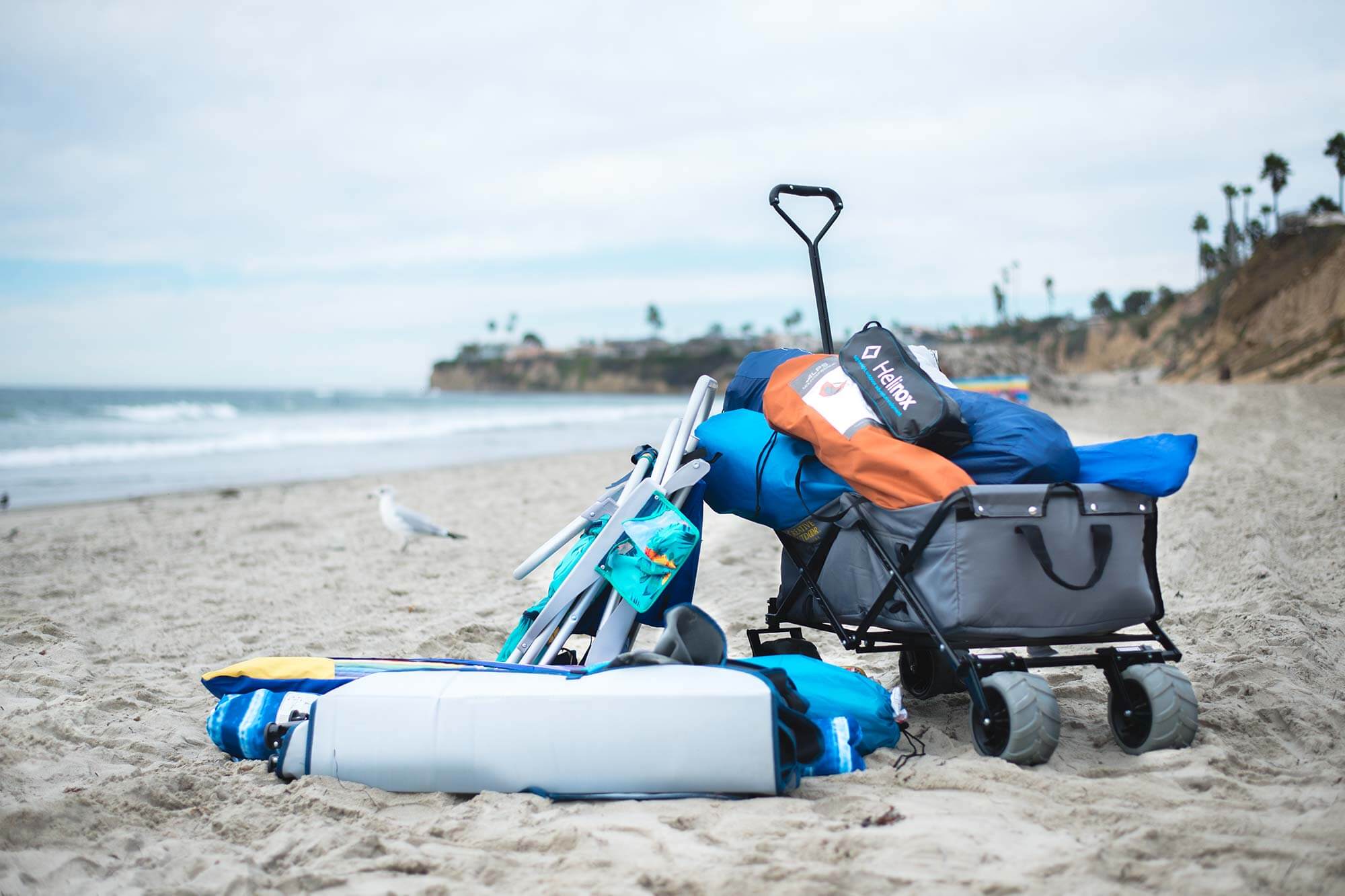 wagon loaded with beach gear on the sand