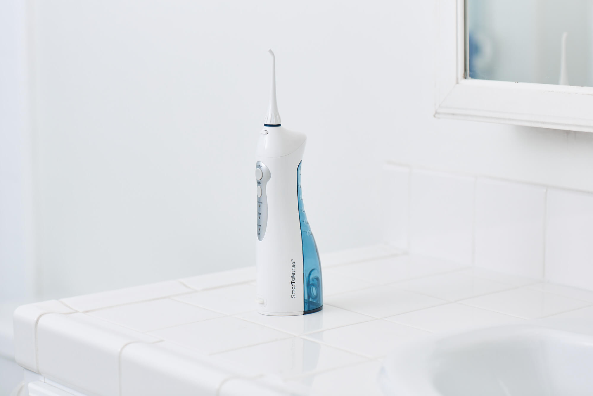 Smartoiletries cordless water flosser in a bathroom