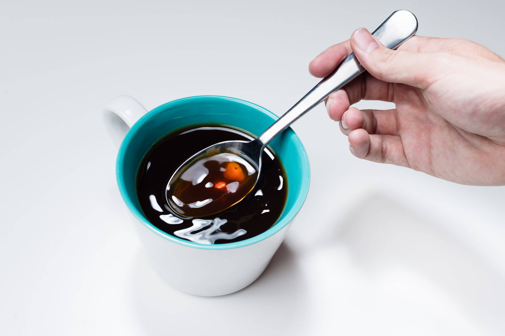 a spoon in a coffee cup for taste testing