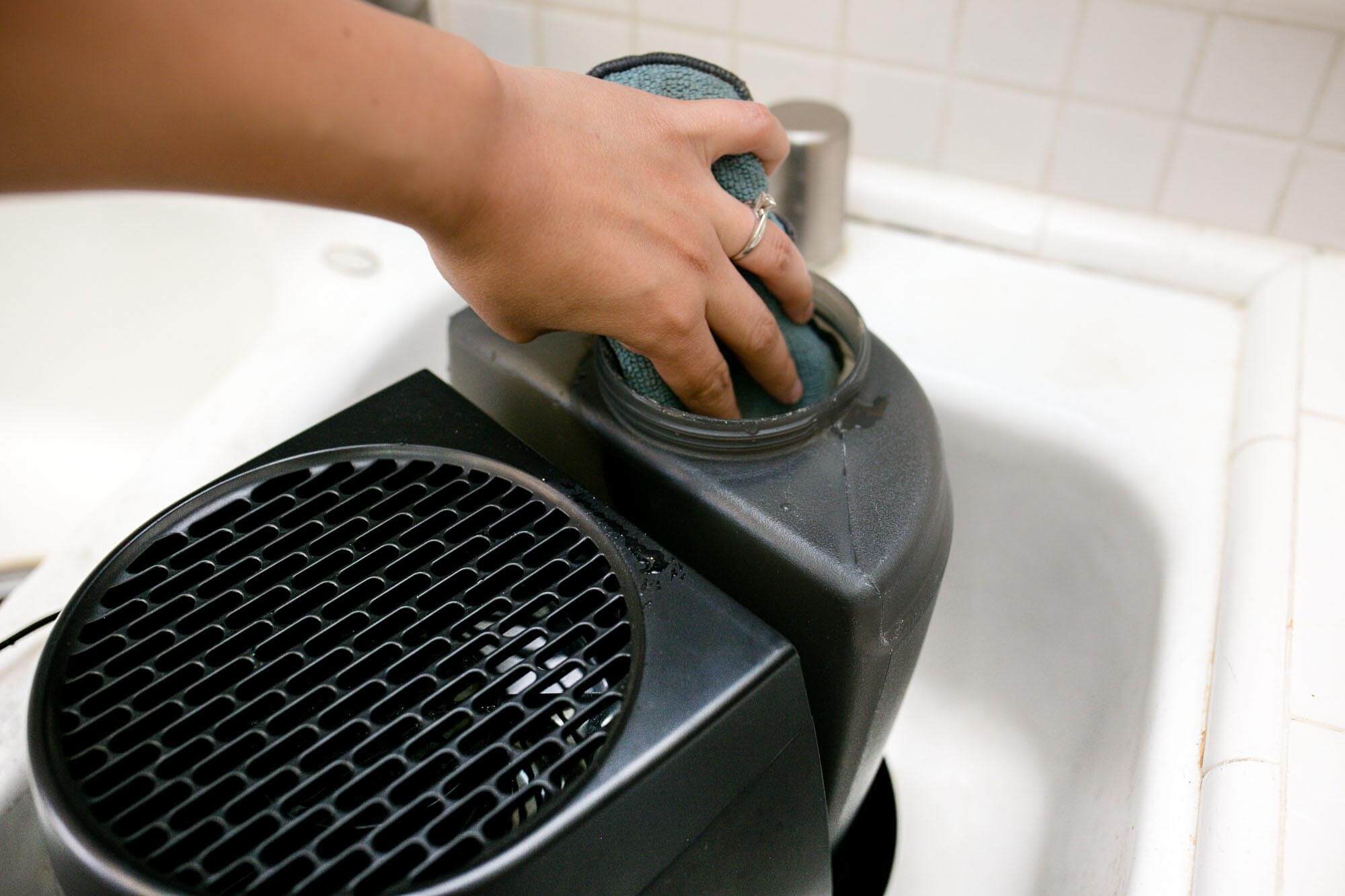 scrubbing a Honeywell HEV320B tank with a sponge