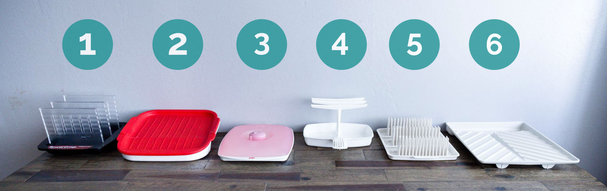 Six microwave bacon cookers on table