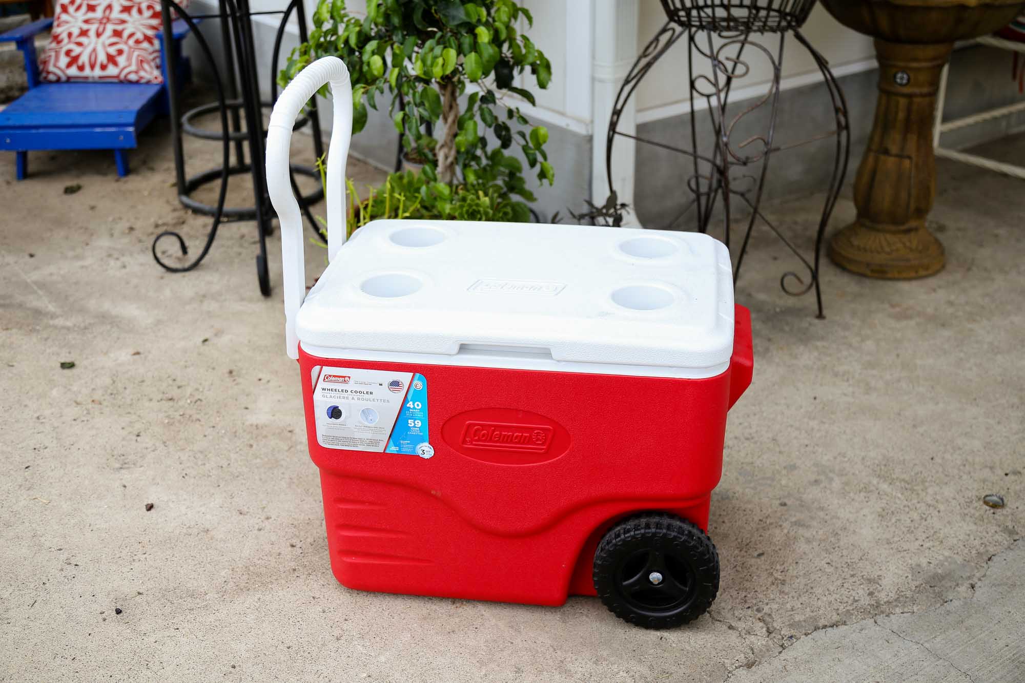a red Coleman - wheeled cooler