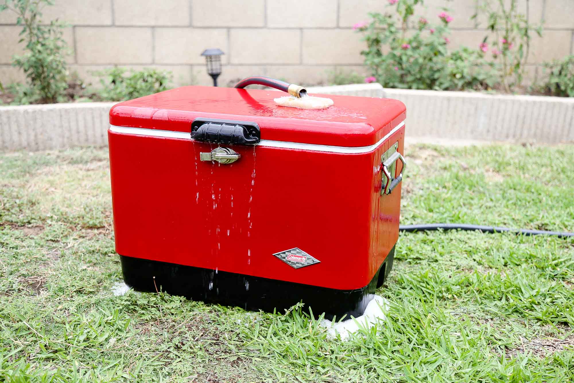 washing the outside of a red cooler