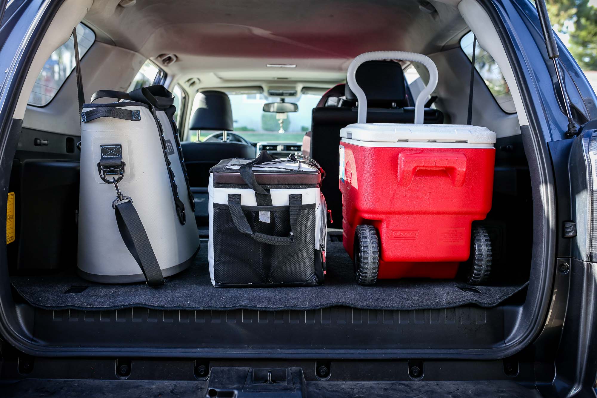 coolers being packed into trunk of a car