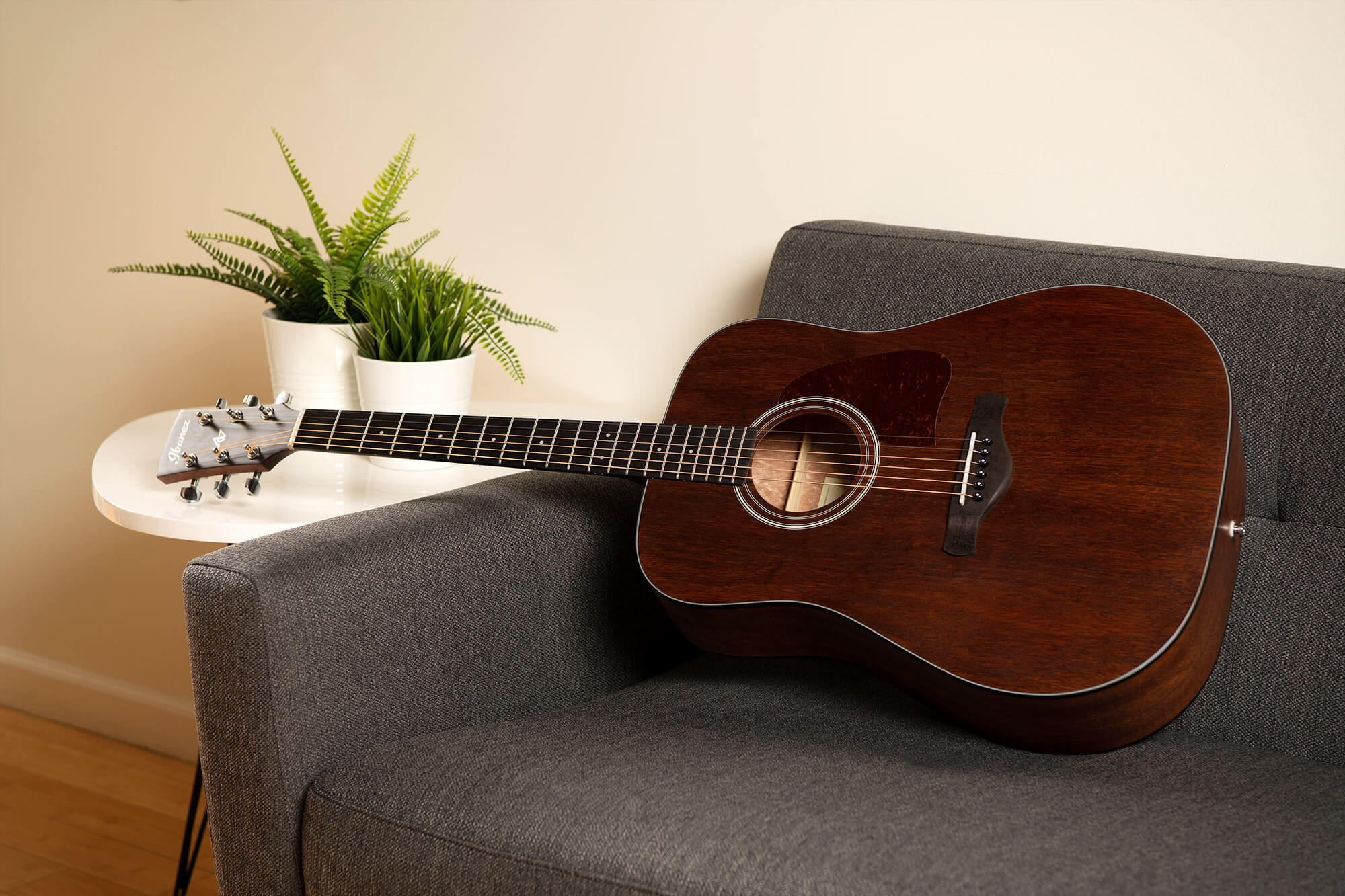 Ibanez AW54 guitar on a couch
