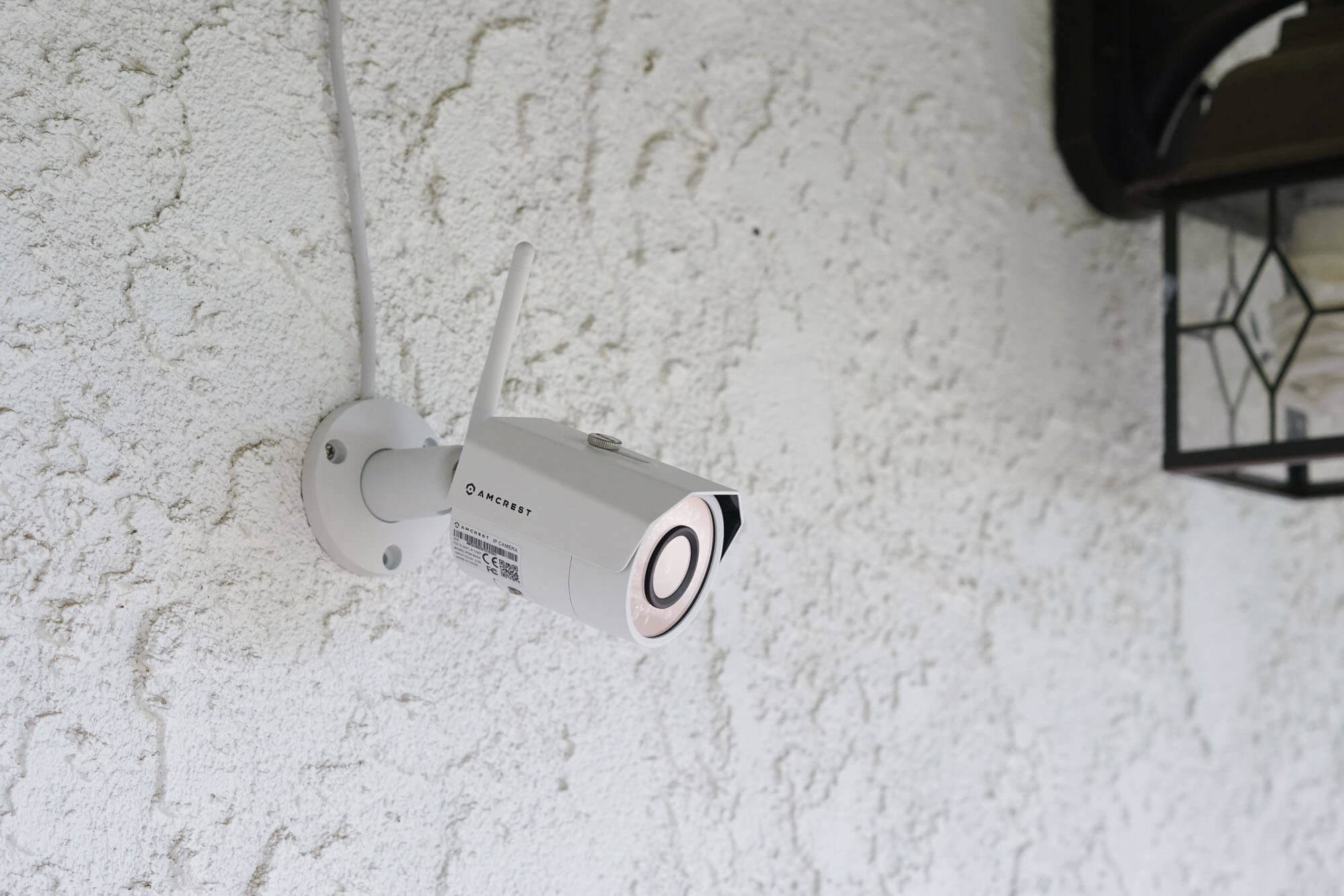 Amcrest security camera mounted to exterior wall