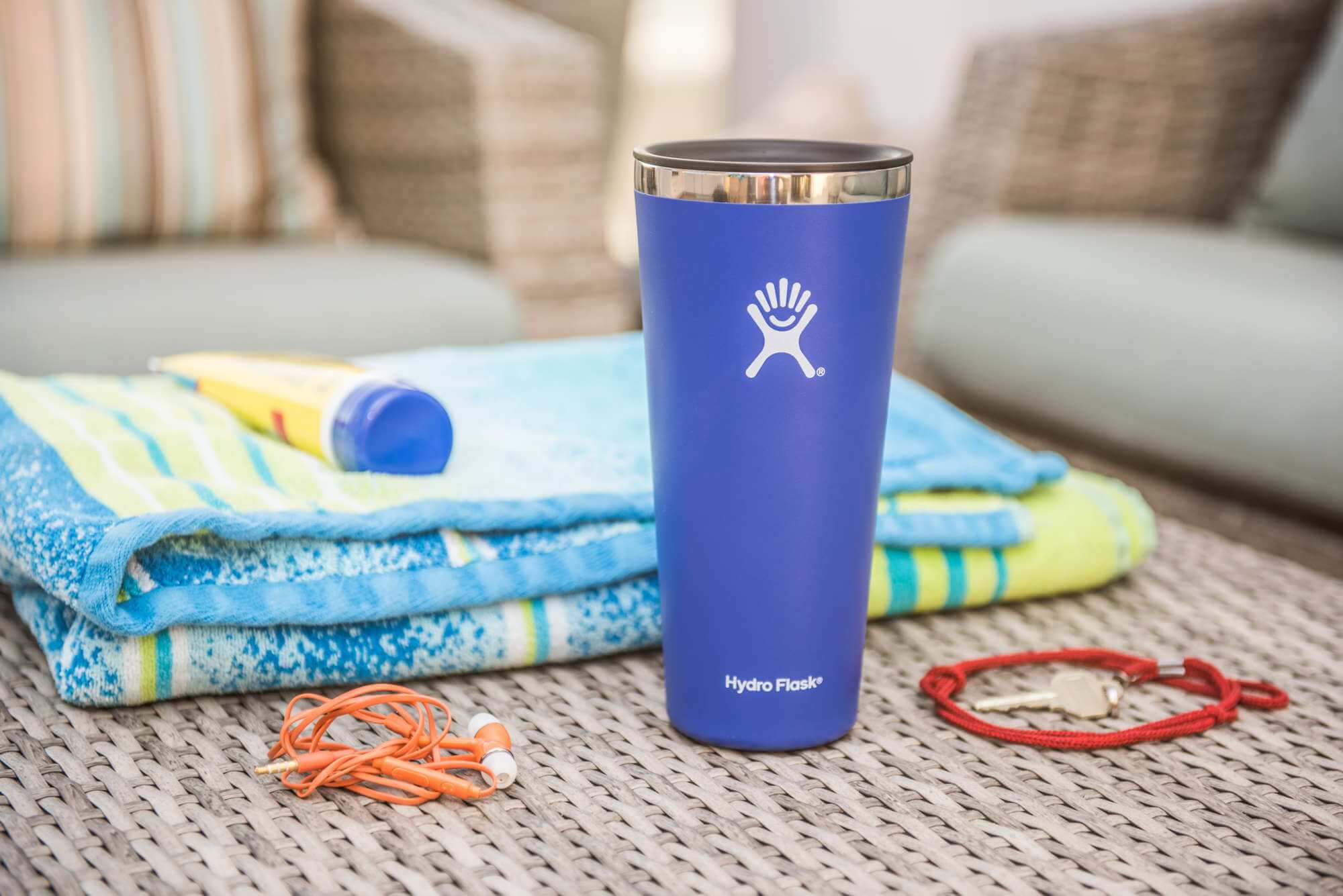 Blue tumbler next to beach towel