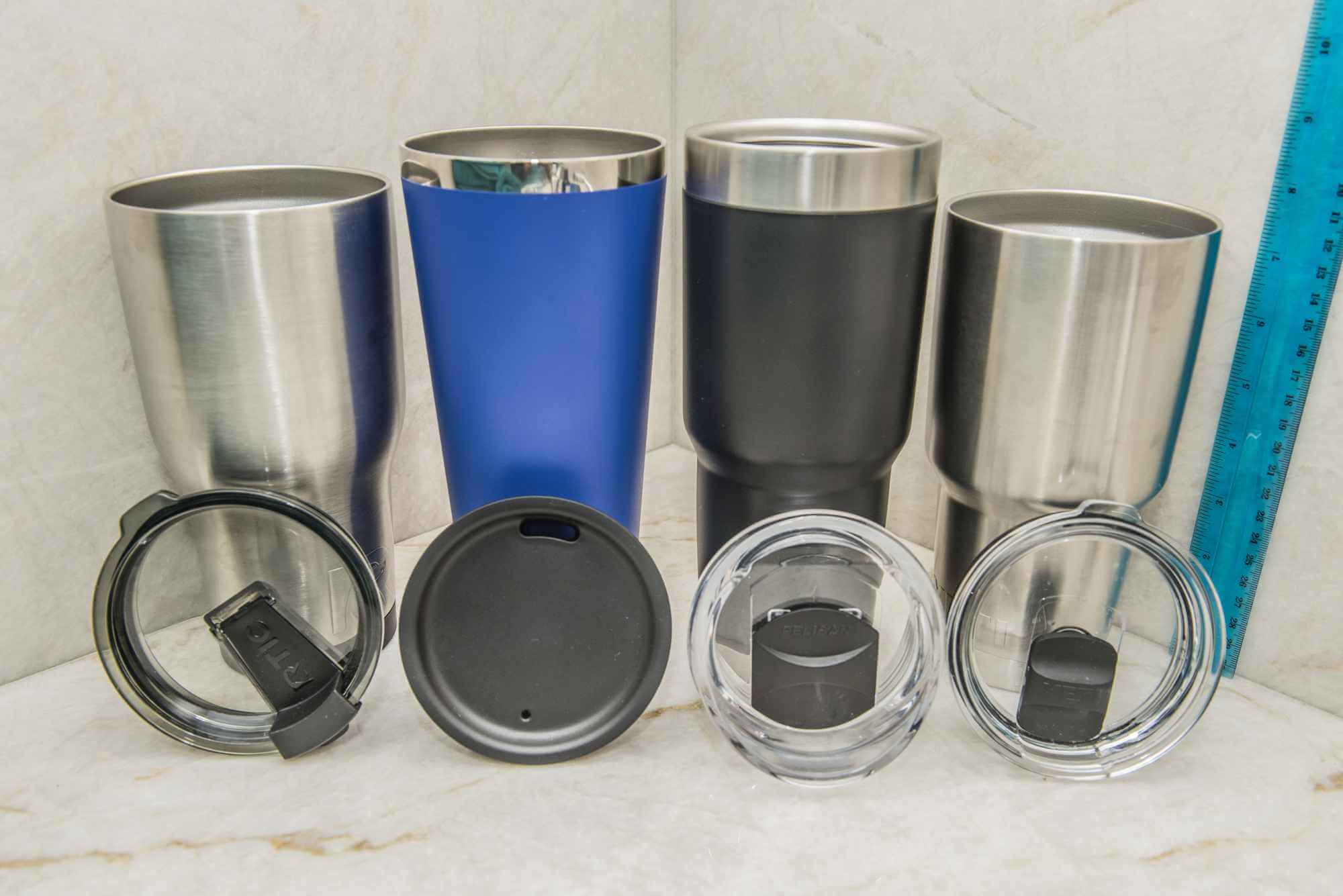 Group of four tumblers and lids