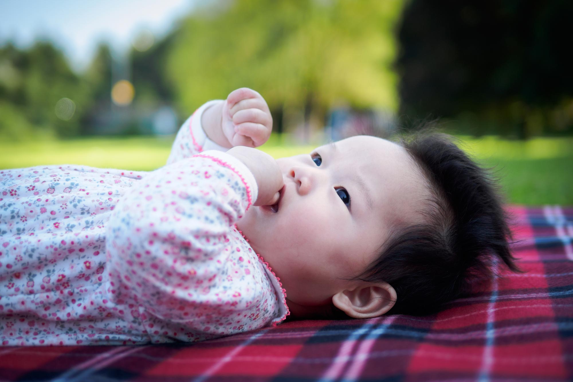 baby laying in grass outside