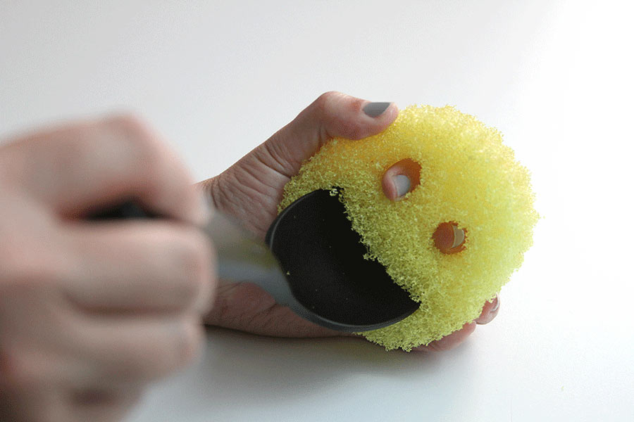 cleaning a spatula with scrub daddy