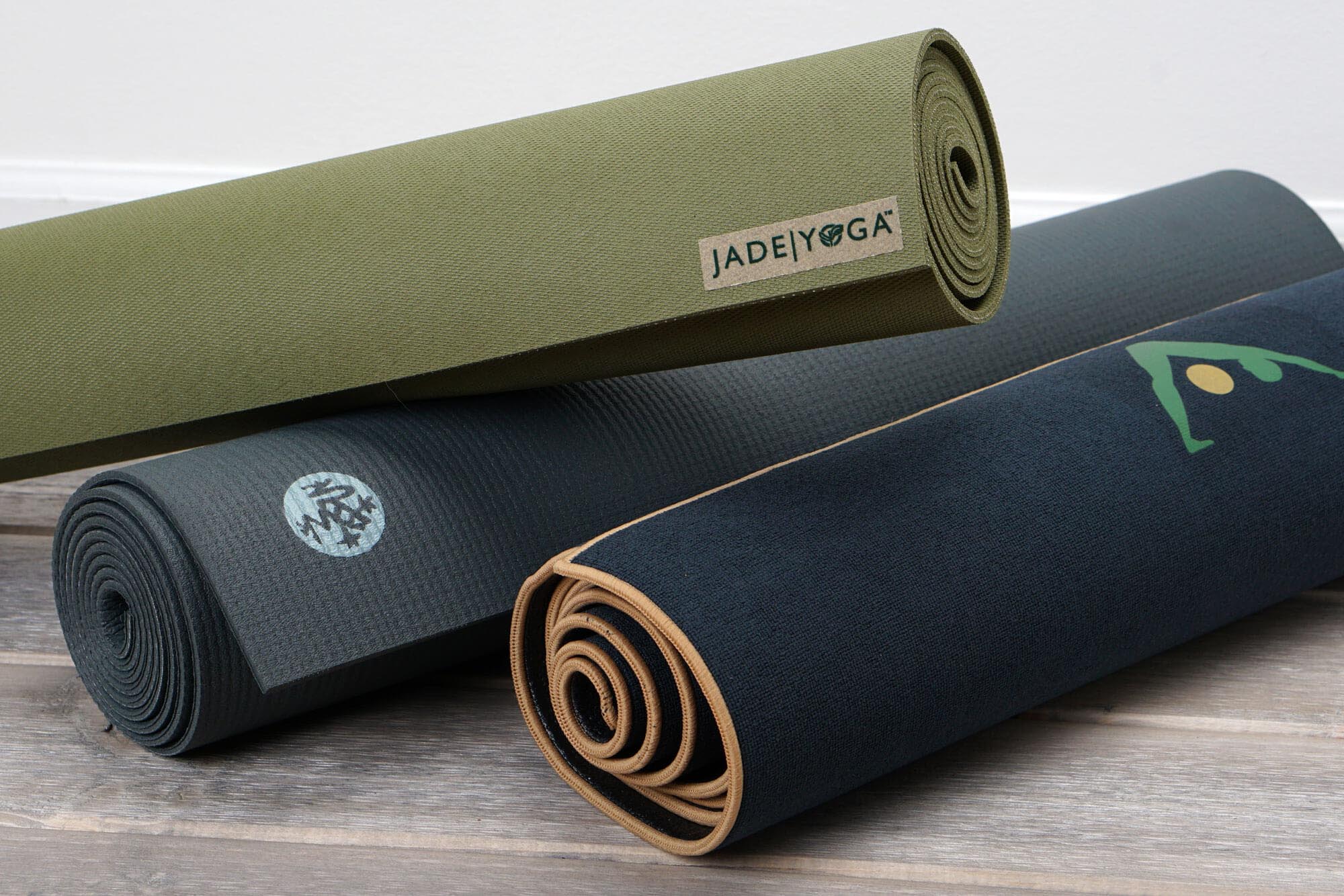 three rolled up hot yoga mats