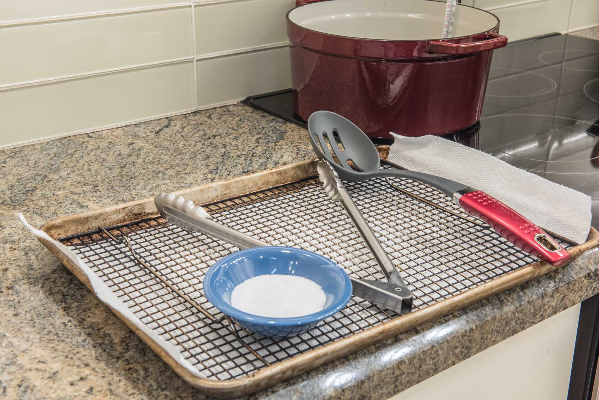 frying rig setup with salt, tongs and slotted spoon