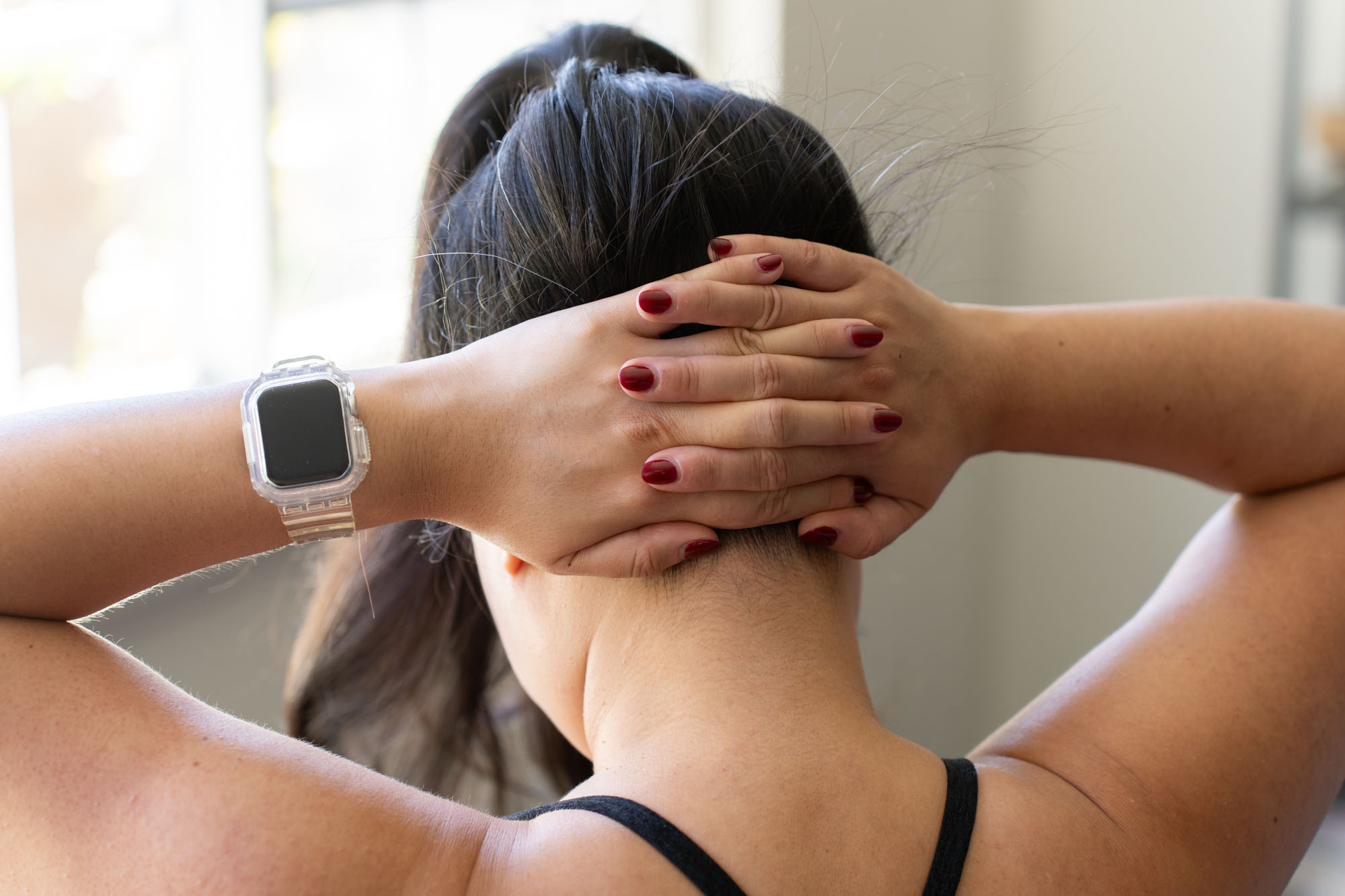 interlocked fingers, pushing head forward