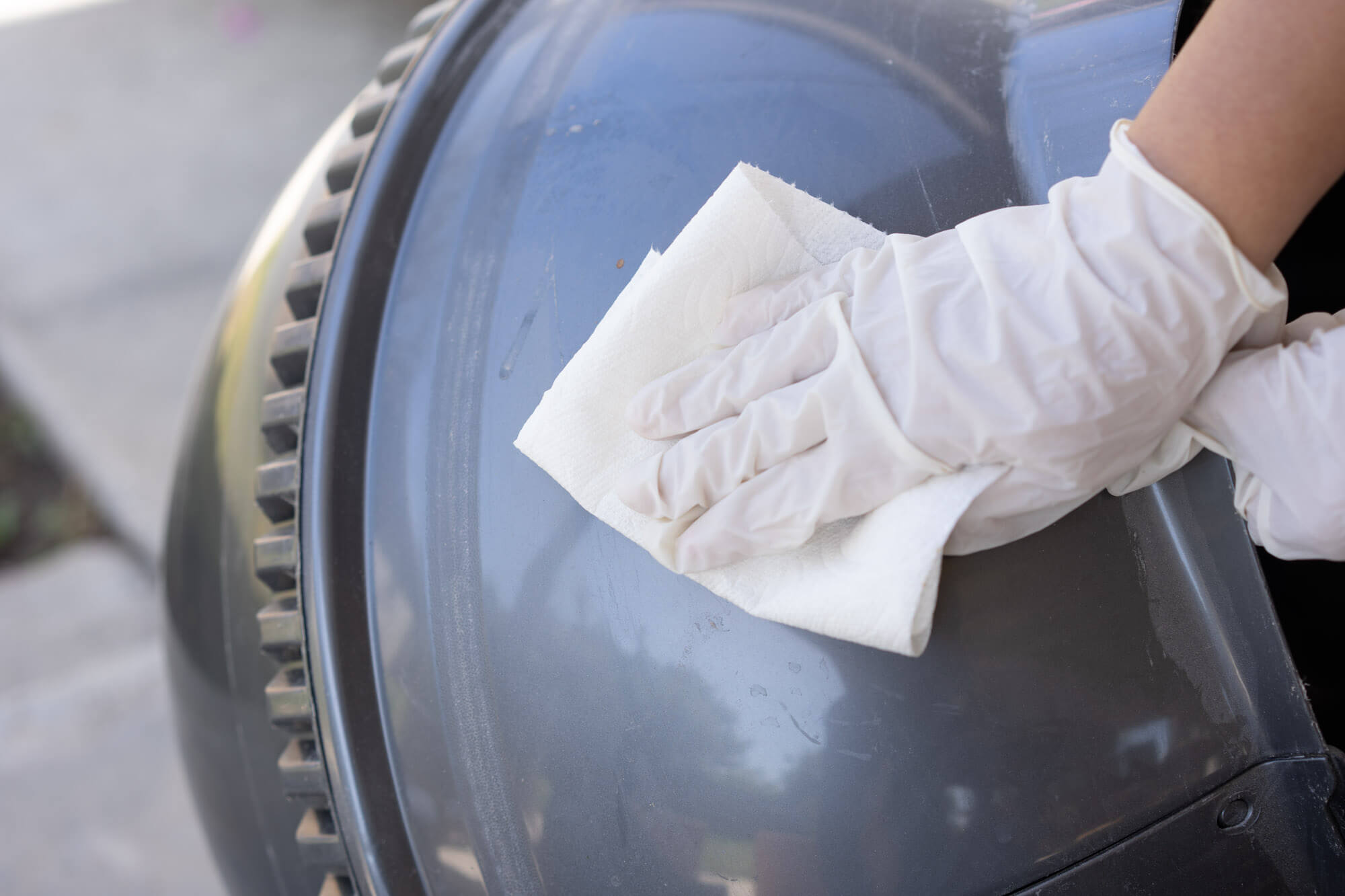 wiping Litter Robot surface